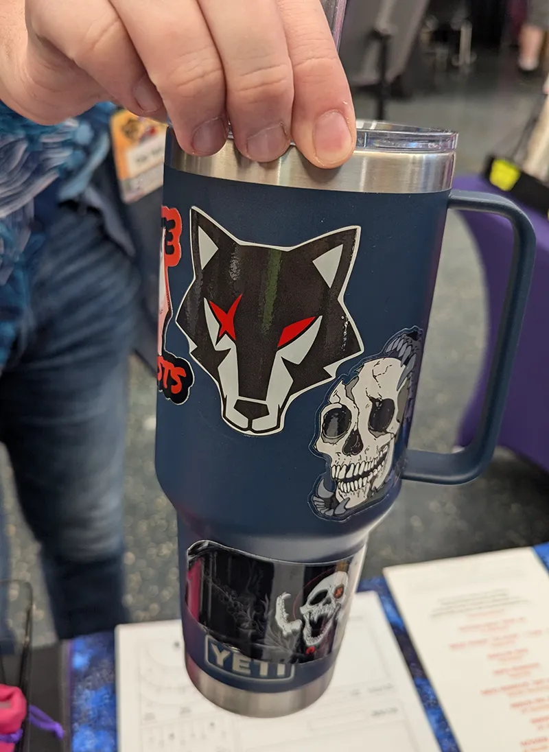 Image featuring stickers, including a Street Wolves wolfpack sticker on a thermos.